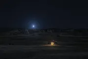 Regulus, the Heart of the Lion, blue-white and low over a dark ridge, a single lit window below it