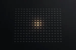 Hundreds of identical small tiles fading into the dark, with only a handful at the center lit in warm amber and connected by faint lines, evoking a sprawling system reducing to a few core primitives