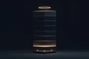 A tall cross-section of a dark tower lit floor by floor, a single glowing line between two nodes at the foundation and one ring of light at the roof