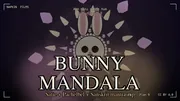 BUNNY MANDALA thumbnail. Plan 9 the cyborg bunny centered in the breakdown frame with the contemplative expression, big cream-fur head with pink inner ears, large white-sclera eyes meeting the camera, pink nose, soft pink mouth. A six-ring lotus mandala surrounds the bunny: outer rose lotus petals, mid teardrop petals, gold triangle flares, an inner yellow dot ring, plus a halo of cream-furred tiny bunny silhouettes orbiting around. Warm pink and gold rose-and-gold palette of the Eyes Meet section. Title BUNNY MANDALA in large cream serif glow letters bottom-center, BUNNY in rose halo, MANDALA in gold halo, subtitle Satie + Pachelbel + Sanskrit mantra-rap in gold below. Top center the Devanagari Aum mani padme hum mantra in rose. Top-left brand NAPKIN FILMS in cream mono. Bottom-right runtime 3:29 Plan 9 CC BY 4.0 in cream. Corner brackets framing the composition.