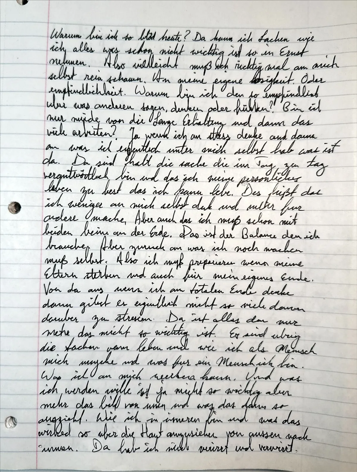 Handwritten notebook page in black ink, a full page of German cursive on lined paper with a red margin line and three punched holes