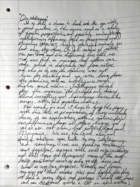 Photo of a lined notebook page covered in cursive handwriting, headed On Intelligence