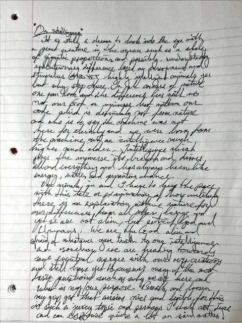 Photo of a lined notebook page covered in cursive handwriting, headed On Intelligence